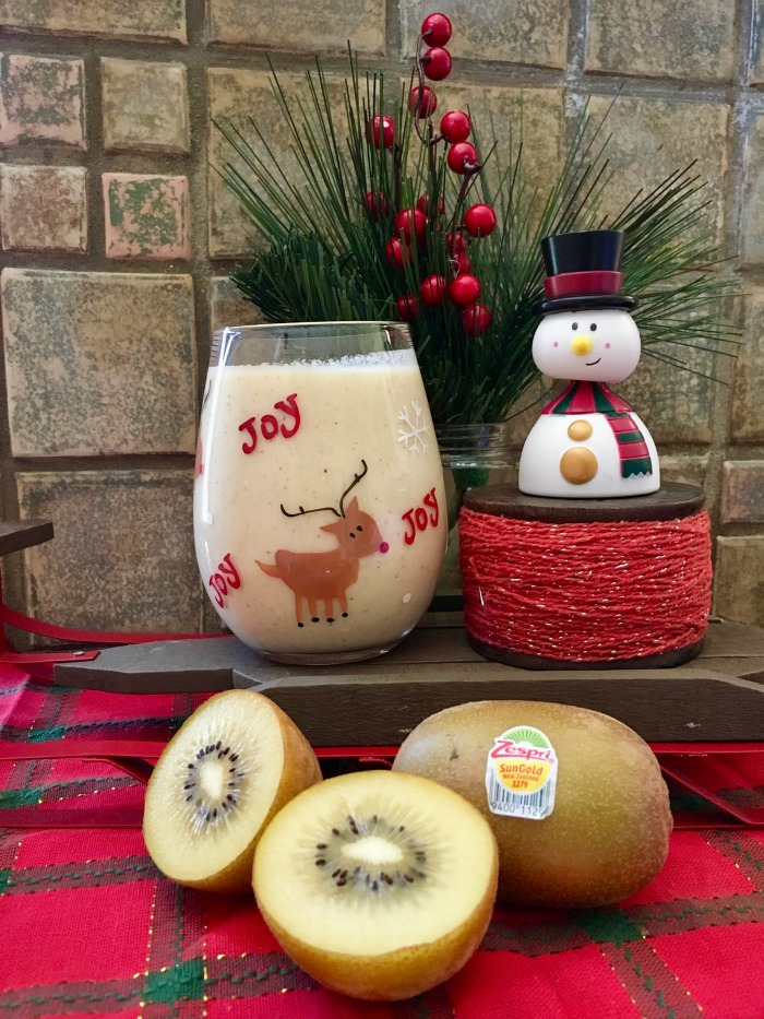 eggnog recipe image with kiwi decorated with a snowman and red holiday decor