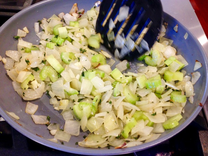 onions and celery cooked being cooked in a pan with a spatula