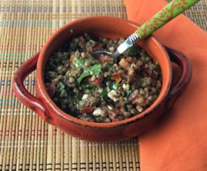 lentil salad in orange bowl on placemat