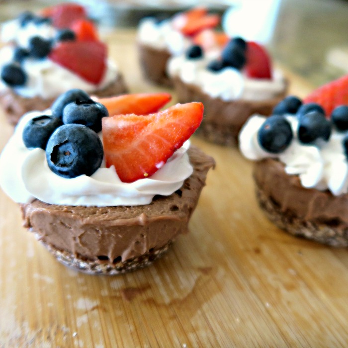 gluten free vegan chocolate cheesecake with berries on top