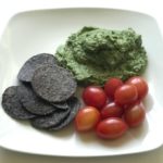 spinach artichoke dip with chips and tomatoes