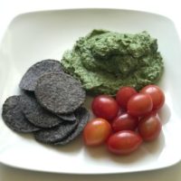spinach artichoke dip with chips and tomatoes
