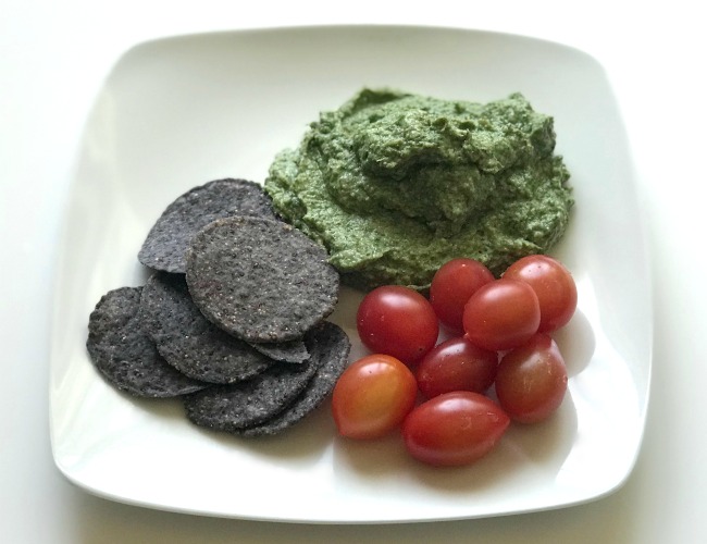 spinach artichoke dip with chips and tomatoes